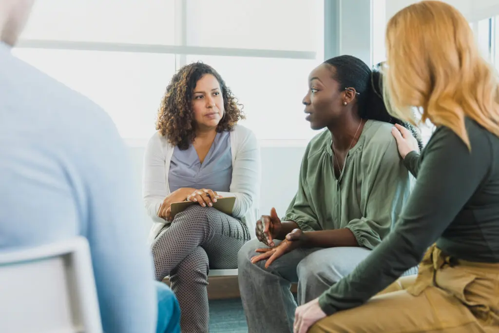 Group of women participating in group therapy supporting each other