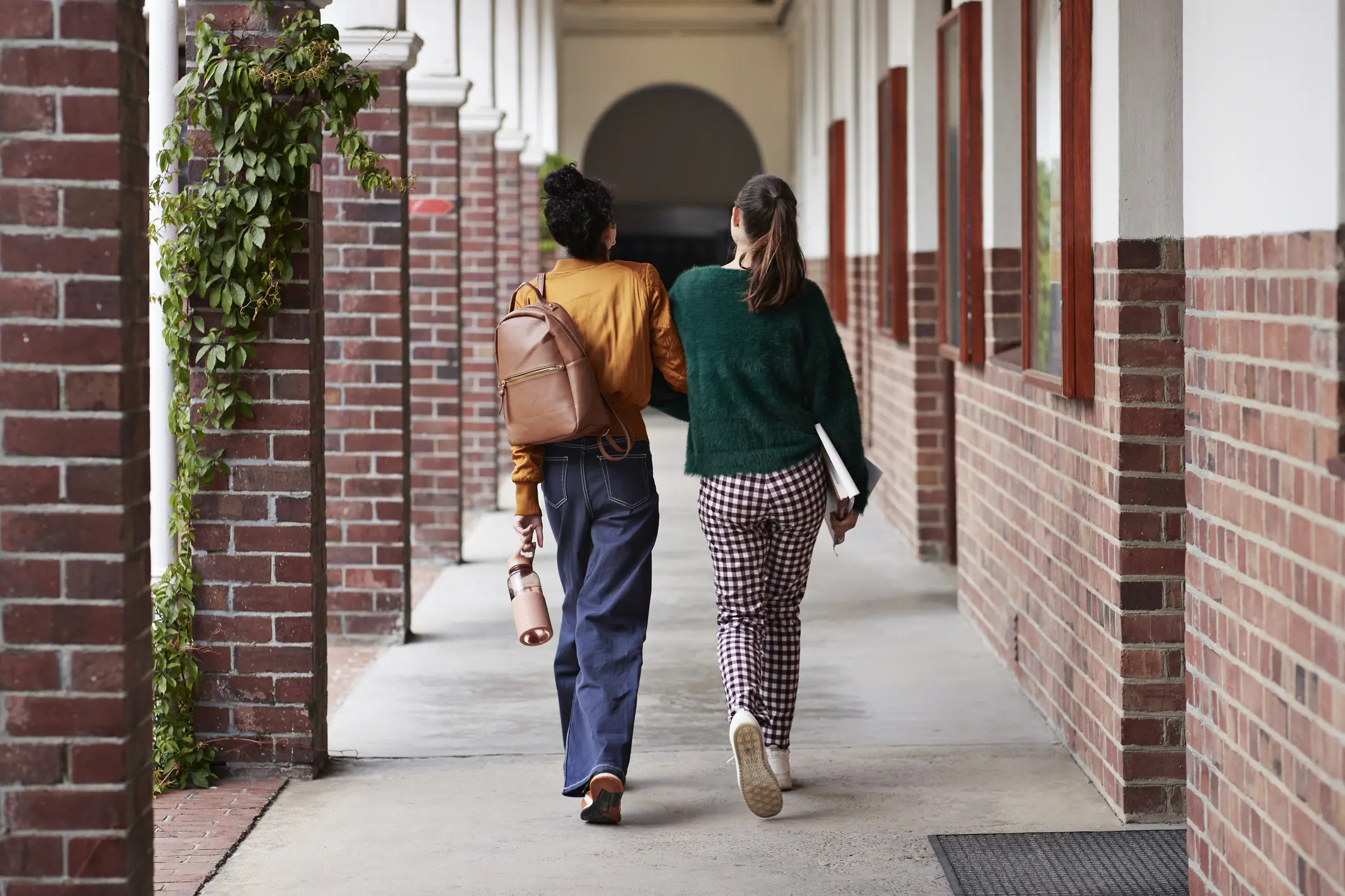 Two teens walking outside.